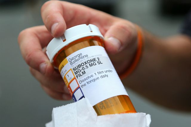 Newly-released inmate George Ballentine holds his prescription medicine Suboxone outside a pharmacy in Greenfield, Massachusetts